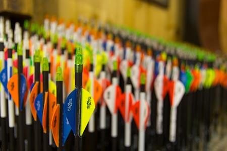 Rows of colorful fletched arrows at Straight Arrow Archery