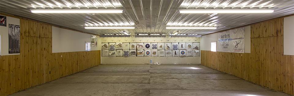The indoor shooting range at Straight Arrow Archery with numbered target butts